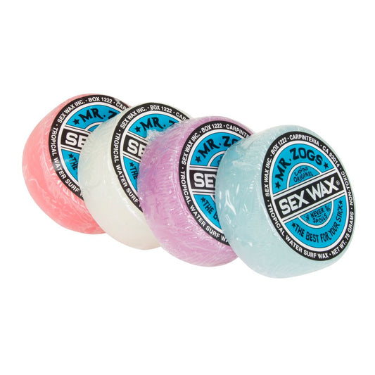 Four circular bars of Mr. Zogs' Sex Wax in pink, white, purple, and blue are crafted for surfboard needs across various temps using the trusted Tropical Waters formula.