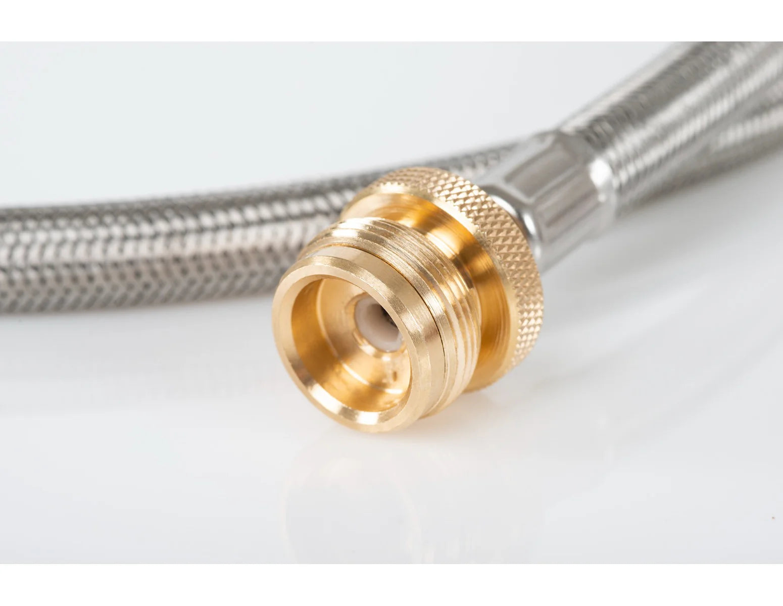 Close-up image of a GSI Propane Adapter Hose with a brass connector fitting, ideal for larger tank conversion or camp stove connection, on a white background.