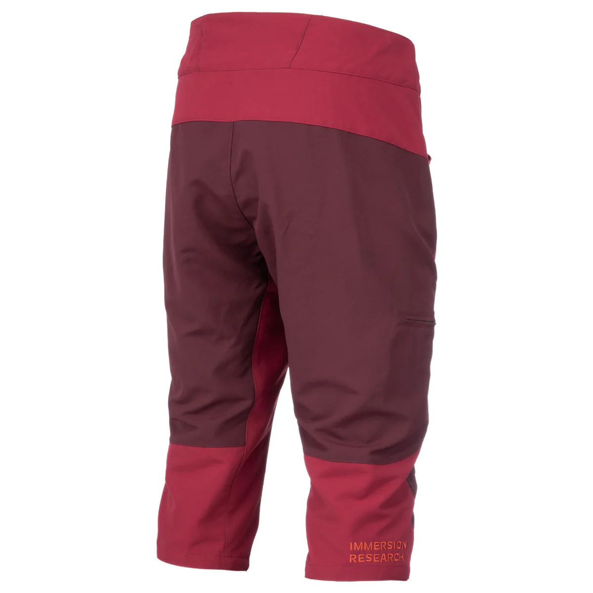 A pair of two-tone maroon and red knee-length outdoor shorts with "Immersion Research" written on the right leg, featuring a paddling fit and an adjustable webbing belt. These are the Shinzer Shorts from Immersion Research.