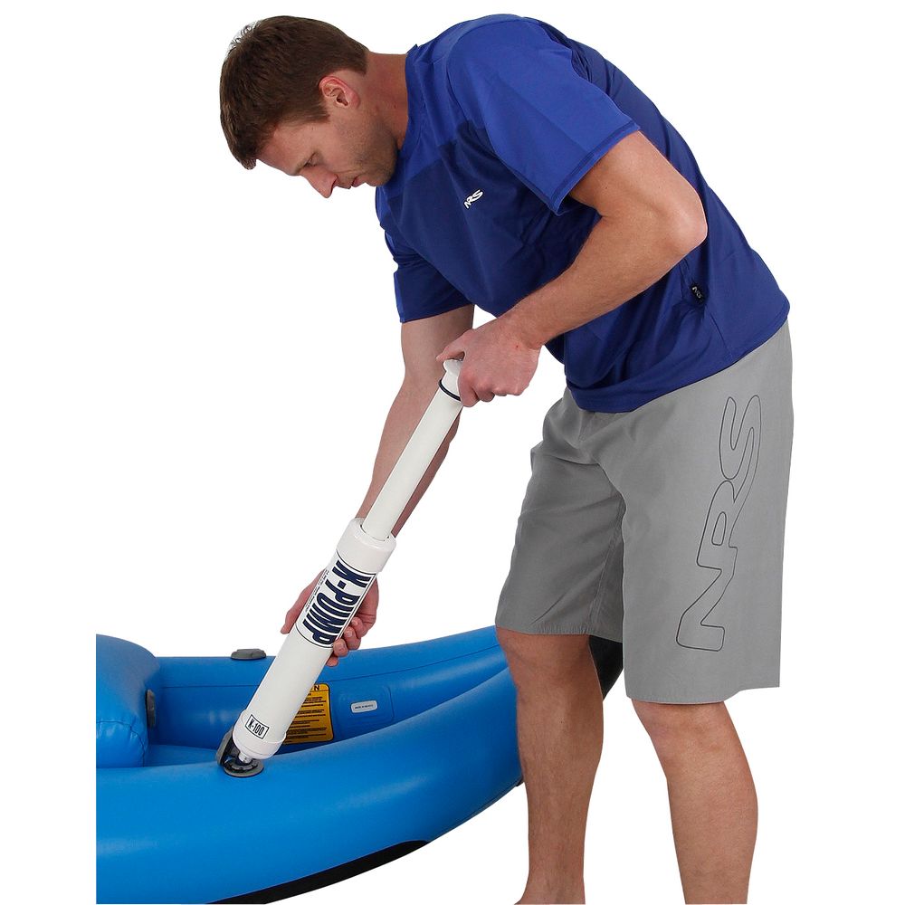 Using a K-Pump K100 from NRS, the person expertly inflates a blue raft, achieving perfect pressure for adventure. The hand pump fits seamlessly with inflatable boat valves, making inflation efficient and straightforward.