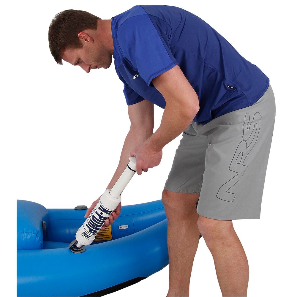 A man in a blue shirt uses the NRS K-Pump Mini to inflate a raft.