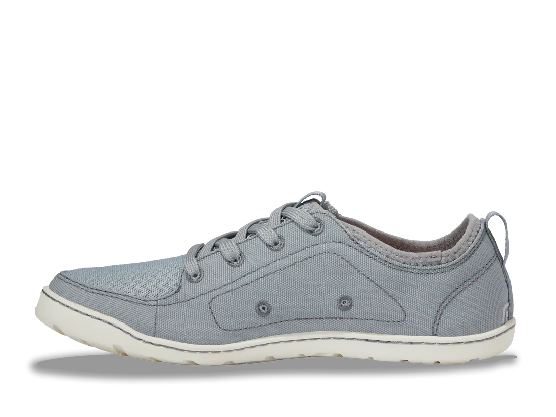 The Astral Loyak - Women's is a gray sneaker with a white sole, laces, and reinforced stitching. Designed with FlexGrip technology for a secure fit, it's perfect for casual wear and outdoor activities like kayaking.