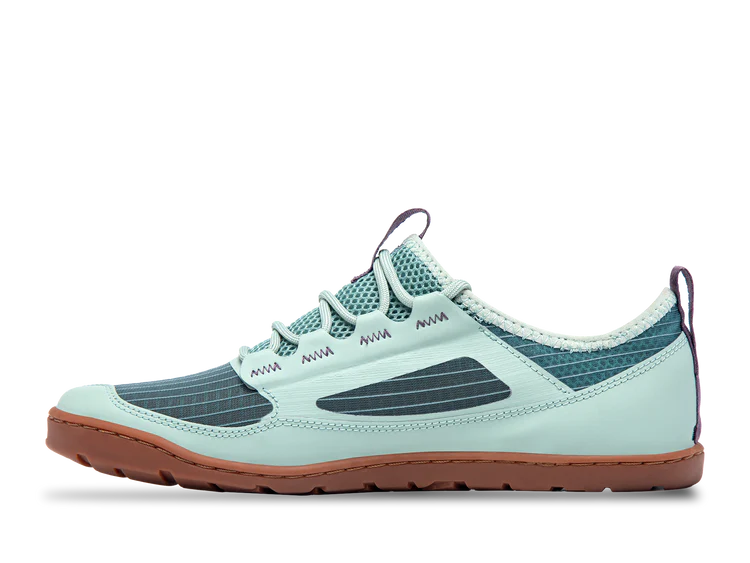 The Astral Loyak AC - Men's is a light blue athletic shoe with a ripstop mesh upper, navy accents, a brown sole featuring G-Rubber outsoles, and rope-style laces. A heel pull tab offers easy wear.