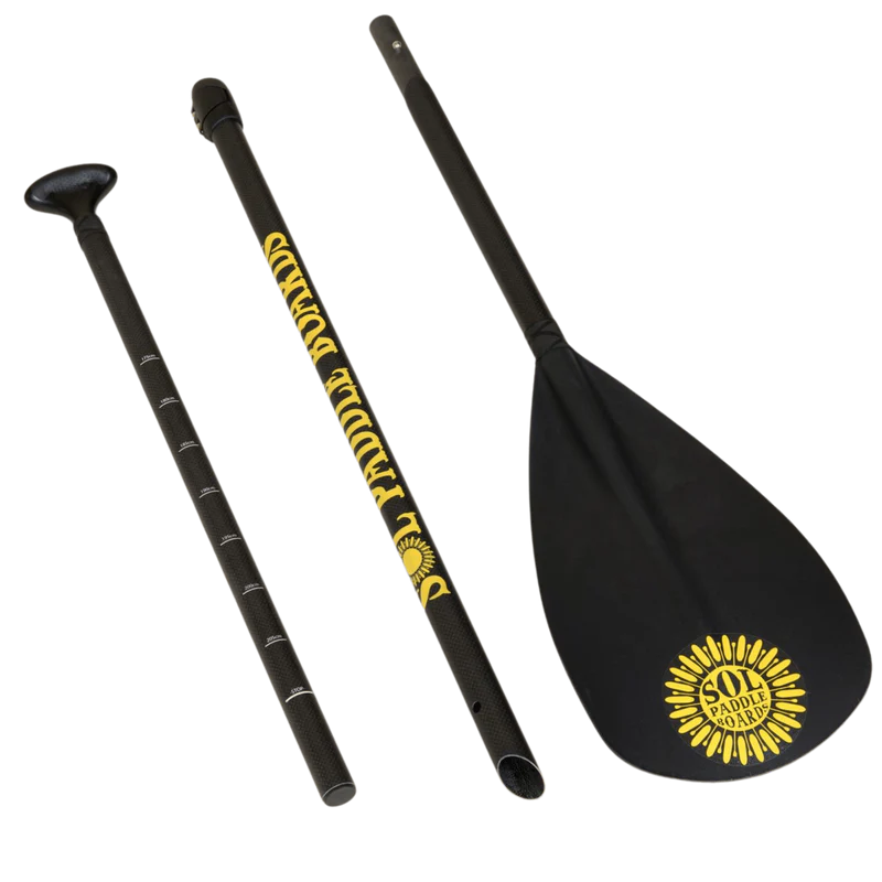 The three-piece black Carbon Blaster SUP Paddle from SOL Paddle Boards, adorned with a yellow sun and "Soul Paddle" text, easily converts for kayak use—making it a versatile accessory for paddle board or SOL Carbon Blaster adventures.