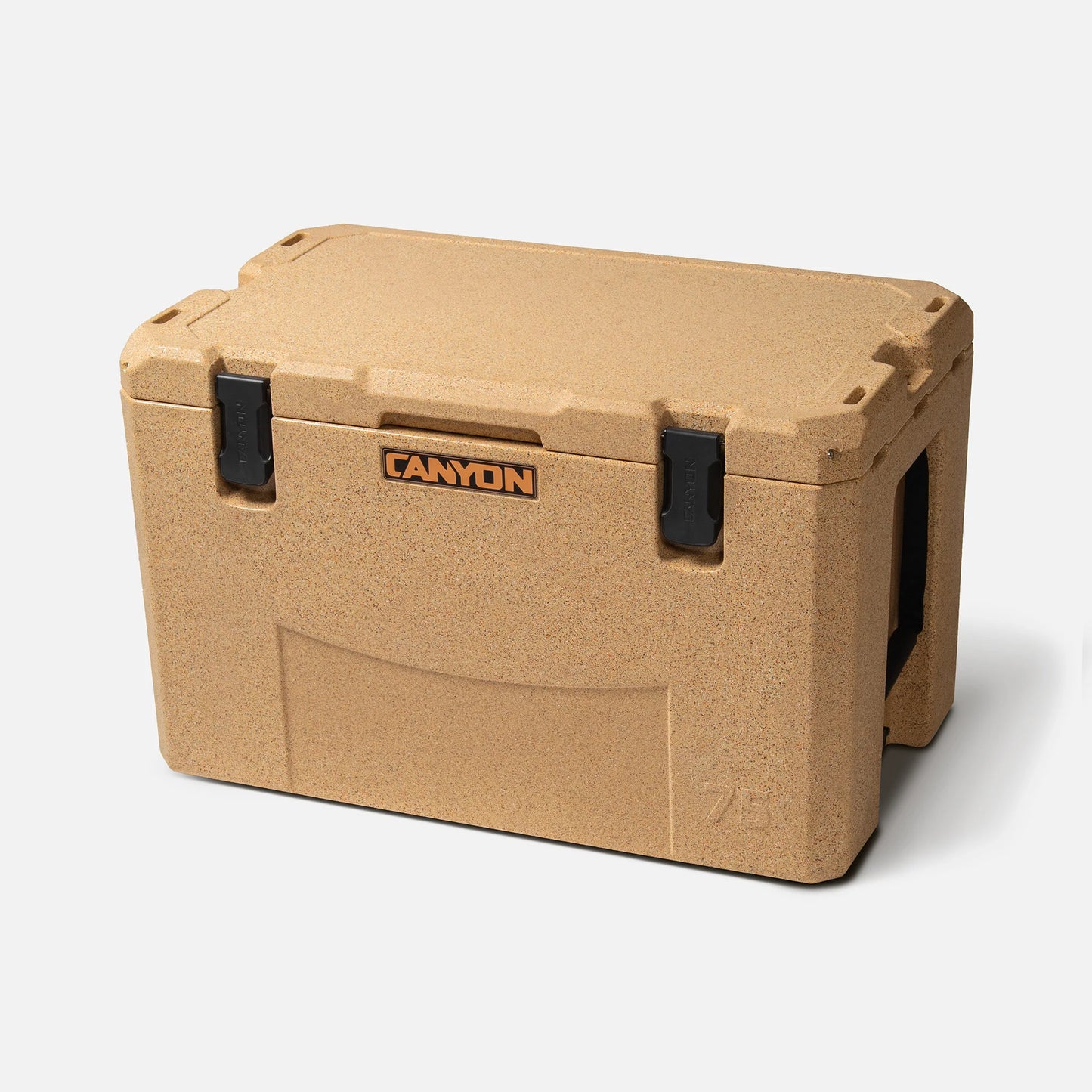 A tan, rectangular Canyon Outfitter V2 Series Cooler with two black latches on its front and the brand name "Canyon" displayed on the top front. Raised imprint of "75" shown on the bottom corner. It features a premium soft touch seal for enhanced insulation.