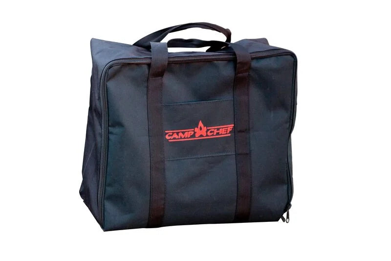 The Camp Chef VersaTop Carry Bag is a black carry bag featuring a red logo and two handles, designed for portable outdoor cooking accessories.