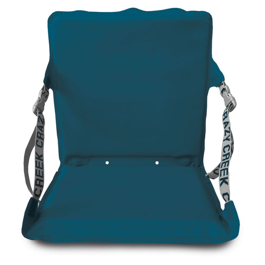 The Crazy Creek Canoe Chair IV, by Crazy Creek, is a portable folding chair with a blue cushioned seat and backrest. It doubles as a canoe chair, features waterproof fabric, and is secured with adjustable straps.