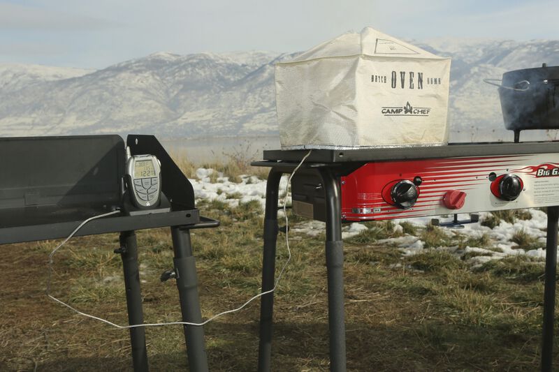 A gas grill with two burners and a Camp Chef Wireless Cooking Thermometer.