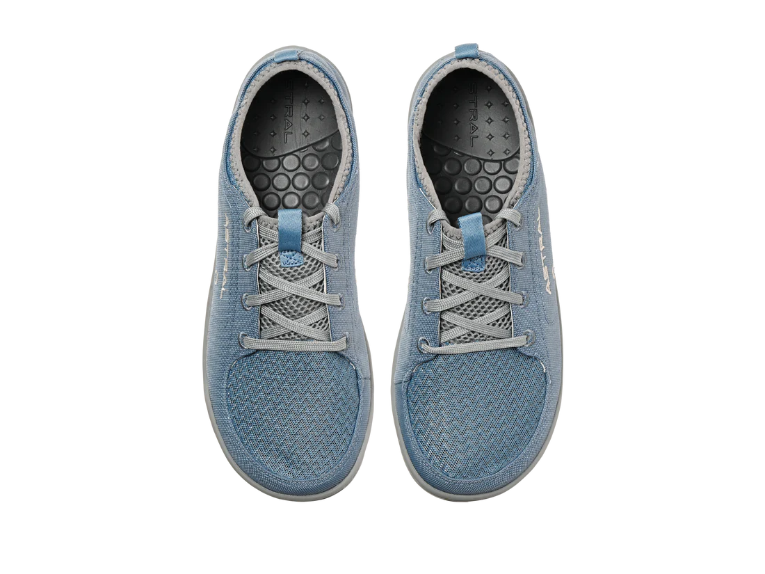 The Astral Loyak - Women's are blue textured canvas shoes with gray laces, a black patterned insole, and FlexGrip for better traction, perfect for kayaking adventures. Viewed from above.