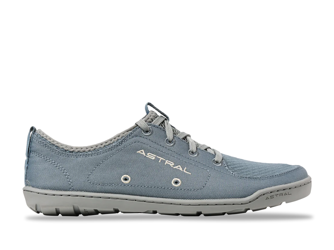 A gray casual sneaker, "Loyak - Women's" by Astral, features a rugged FlexGrip sole and fabric upper. Ideal for kayaking, it offers a low-top design for versatility and comfort.