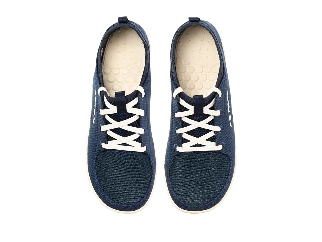 The Astral Loyak - Women's, a pair of dark blue casual shoes with FlexGrip technology, features white laces and off-white interior soles. Perfect for a relaxed day out or versatile water shoes for kayaking adventures.