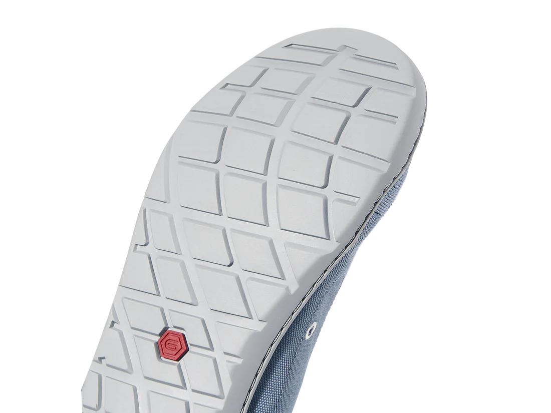 Close-up of the Loyak - Women's shoe sole by Astral, showcasing a geometric tread pattern with a red hexagonal logo by the heel. Perfect for kayaking adventures, this water shoe ensures superior traction and durability.