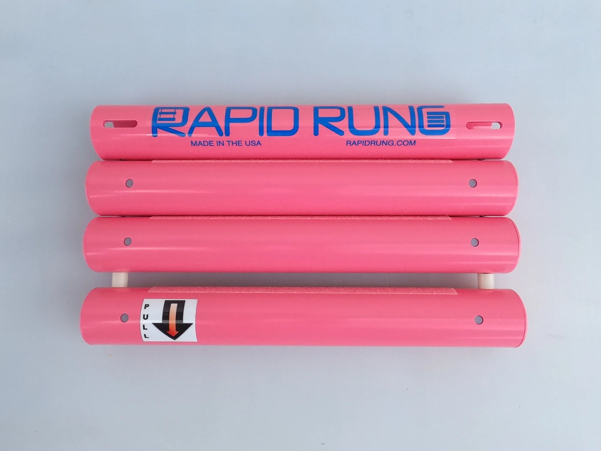 A stack of four pink cylindrical tubes, with the top tube labeled "Raft Ladder" by Rapid Rung, featuring a website and "Made in the USA." The bottom tube displays a down arrow and instructions, making it ideal for quick assembly on any boat ladder.