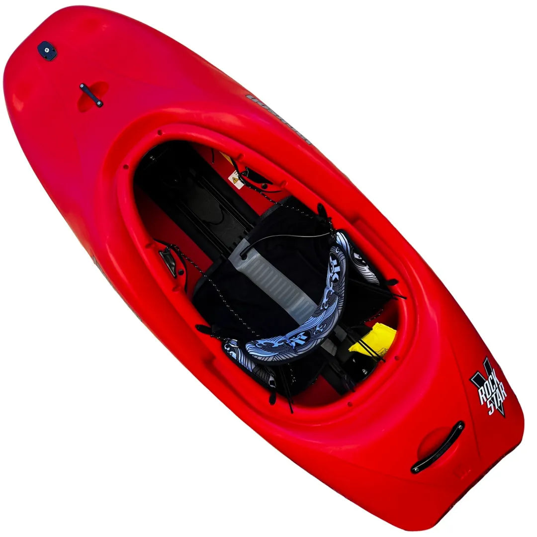 Red kayak with a black seat and foot braces, branded with the "RockStar V" logo on the side, from Jackson Kayak, and equipped with a double-railed drop chine system for enhanced performance.