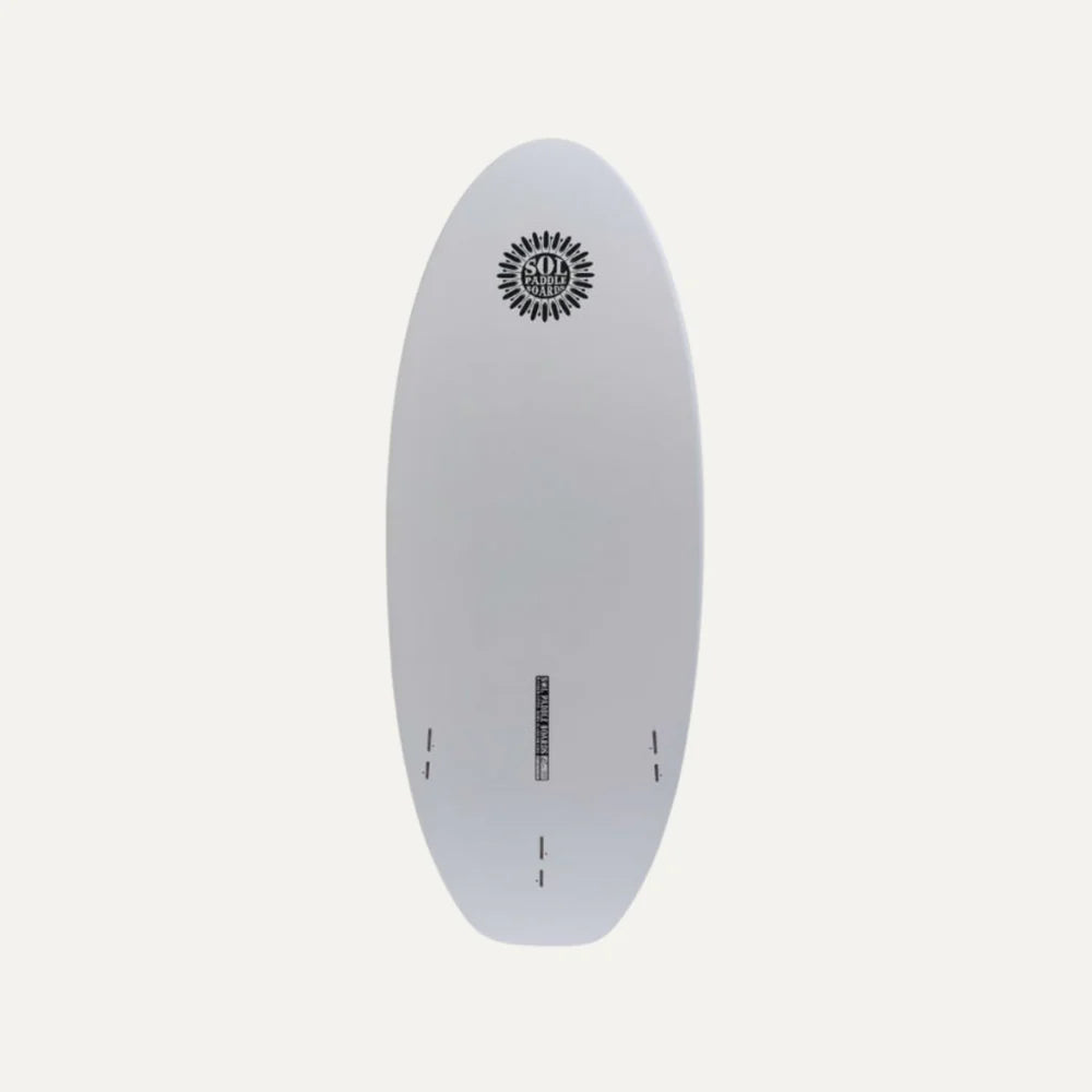 The SOLScepter by SOL Paddle Boards is a white epoxy surfboard featuring a sunburst design near the top and equipped with FCS II Fin Boxes at the bottom for versatile performance.