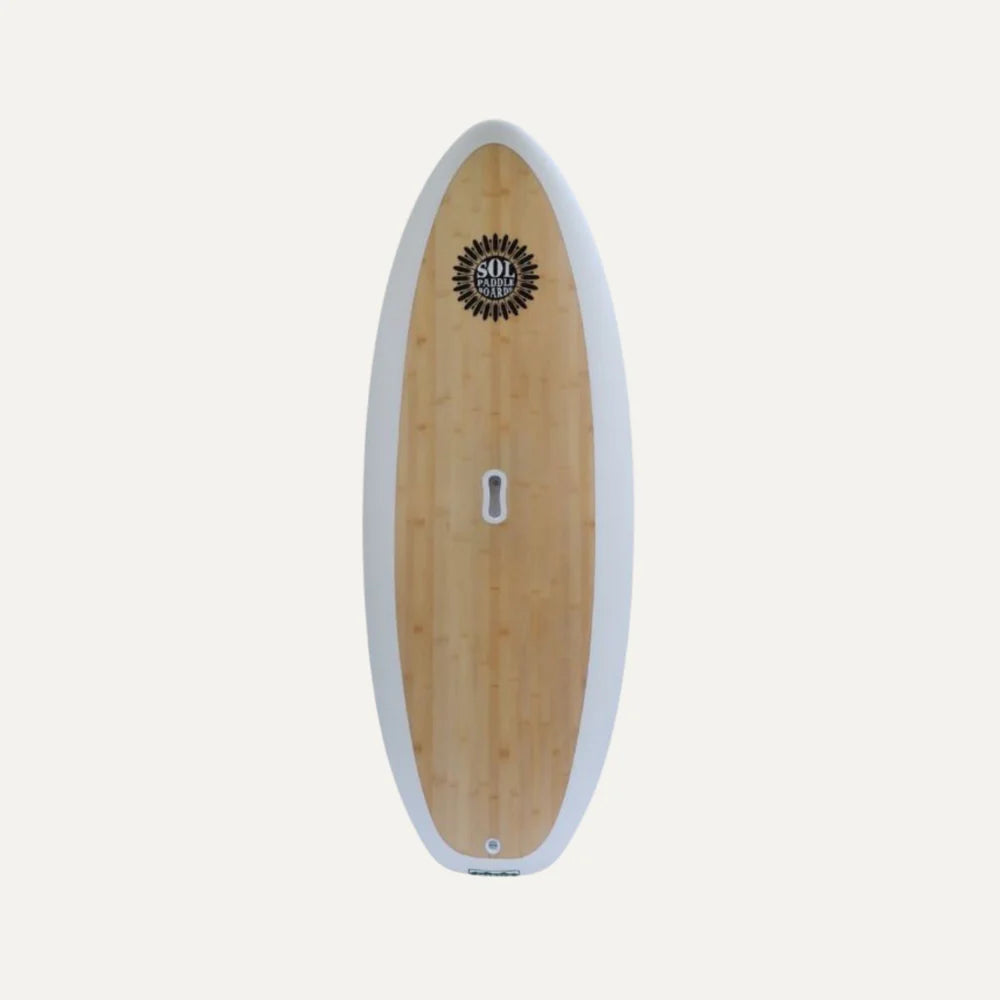 The SOLScepter by SOL Paddle Boards is a sleek epoxy surfboard featuring a wooden finish, white edge, EVA deck pad, and a black logo near the top on a plain background.