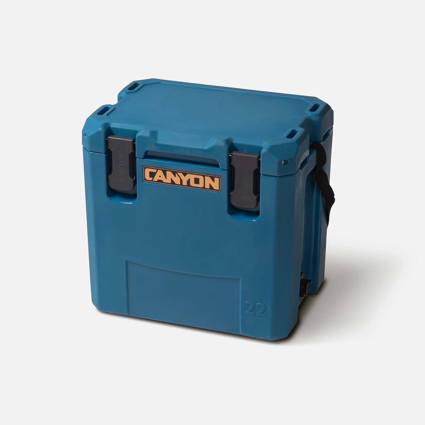 The Canyon Coolers Outfitter 22 V2 Cooler, with rotomolded construction and pressure-injected foam, showcases a sleek blue design and black handle and latches. Ideal for efficient storage, it elegantly sits on a plain background.