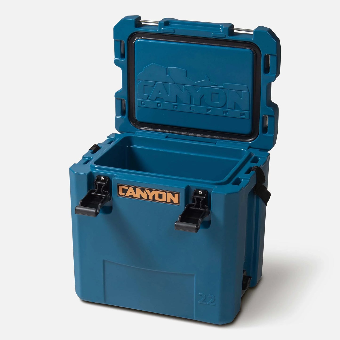 A blue Canyon Outfitter 22 V2 Cooler with its lid open, displaying the interior storage space. The cooler features rotomolded construction for durability, two black latches on the front, and an orange Canyon logo. Plus, it comes with a lifetime warranty for peace of mind.